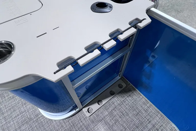 Slide: The Image of 2026 SunCatcher Select 20F boat interior with blue paneling and utility features. - 21