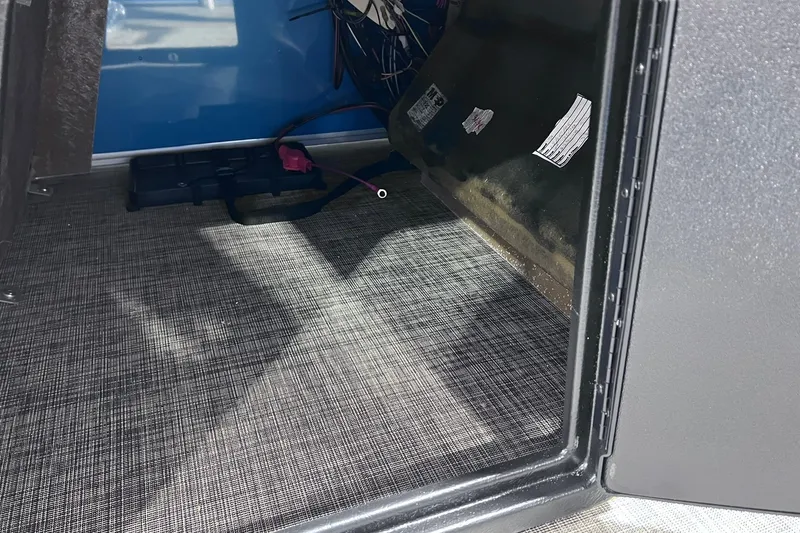 Slide: The Image of Interior storage compartment of 2026 SunCatcher Select 20F with wiring and carpeted floor. - 31