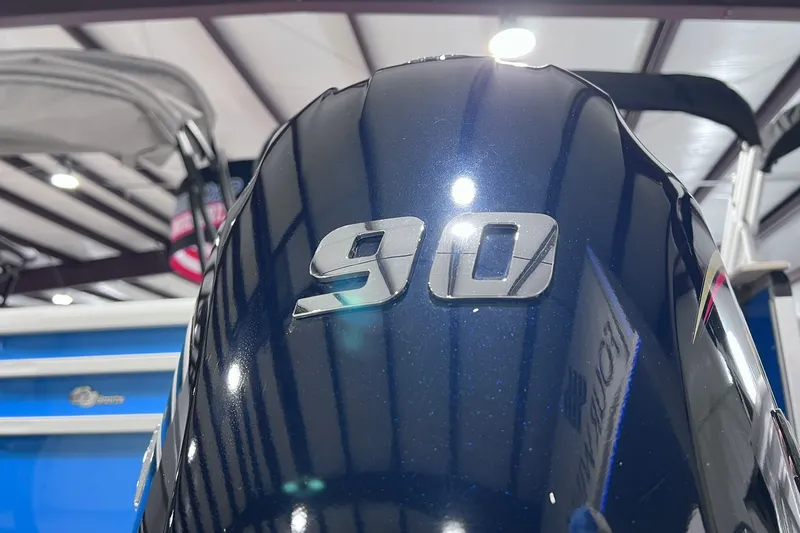Slide: The Image of Close-up of a SunCatcher Select 20F 2026 boat engine with "90" emblem. - 33