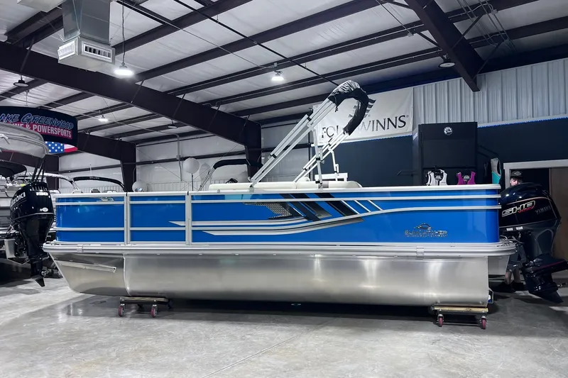 The Image of 2026 SunCatcher Select 20F pontoon boat in showroom, featuring sleek blue design and modern amenities. - 0