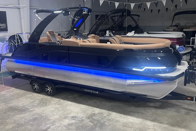 Slide: The Image of 2027 Harris Grand Mariner 250 SL pontoon boat with blue LED lights on trailer. - 2