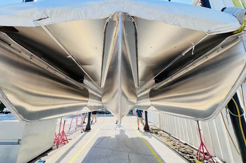 Slide: The Image of Underneath view of a 2027 Harris Grand Mariner 250 SL pontoon boat, showcasing sleek aluminum pontoons. - 61