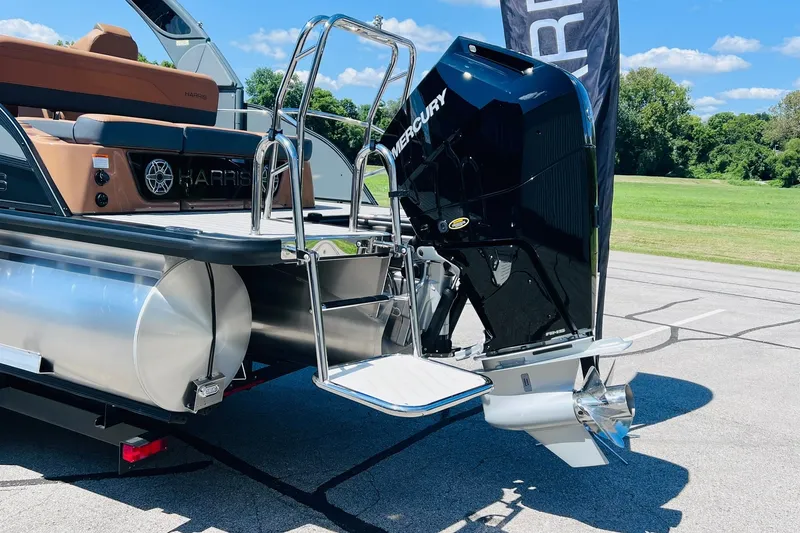 Slide: The Image of 2027 Harris Grand Mariner 250 SL pontoon boat with Mercury outboard motor, docked outdoors. - 35