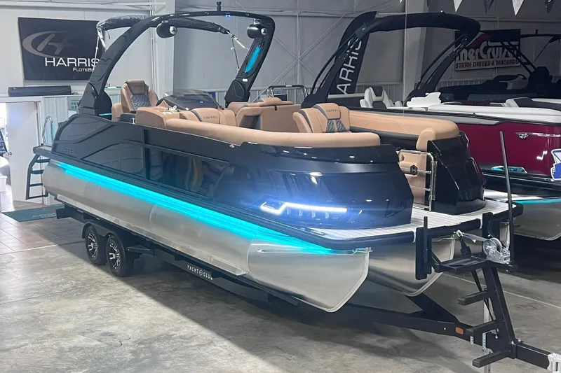 Slide: The Image of 2027 Harris Grand Mariner 250 SL pontoon boat with sleek design and LED lighting. - 1