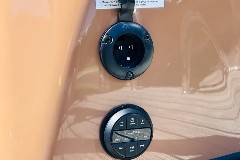 Slide: The Image of Close-up of 2027 Harris Grand Mariner 250 SL audio controls and power outlet. - 41