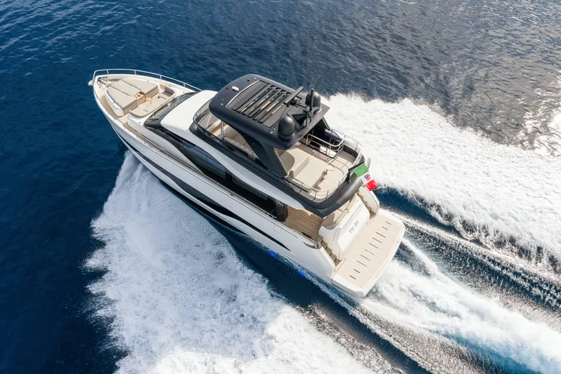 Slide: The Image of 2026 Cranchi Sessantadue 62 yacht cruising on open blue sea, aerial view. - 28