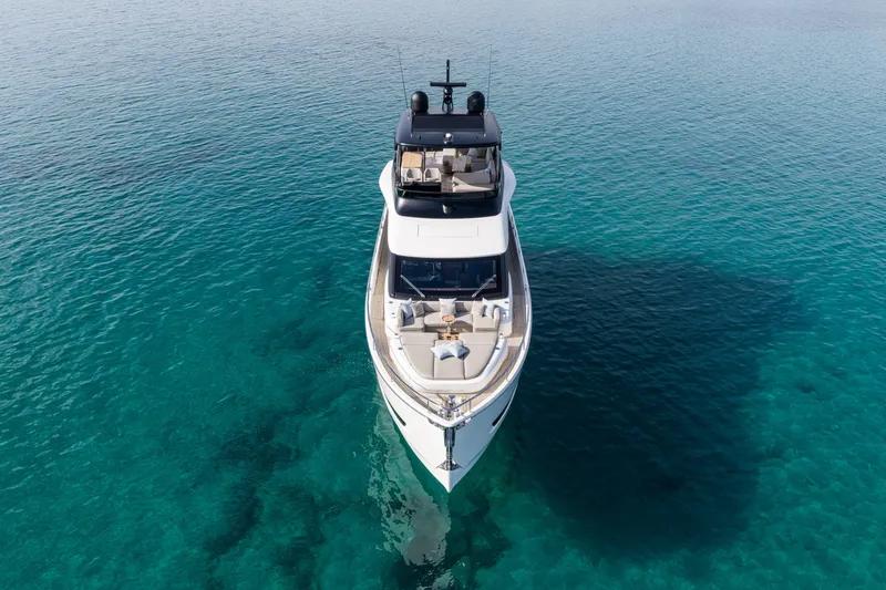 Slide: The Image of 2026 Cranchi Sessantadue 62 yacht on clear turquoise water, aerial view. - 10