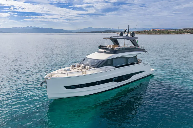 Slide: The Image of 2026 Cranchi Sessantadue 62 yacht on serene blue waters, showcasing sleek design and luxury. - 7