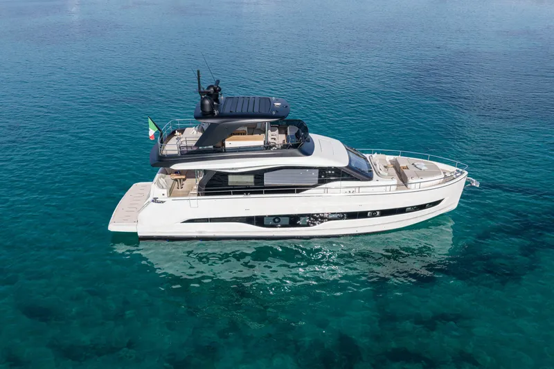 Slide: The Image of Luxurious 2026 Cranchi Sessantadue 62 yacht on clear blue water. - 12