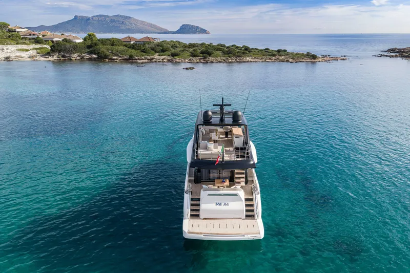 Slide: The Image of Luxury Cranchi Sessantadue 62 yacht anchored in clear blue waters, 2026 model. - 14