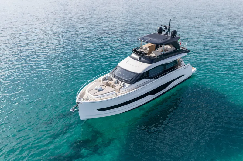 Slide: The Image of 2026 Cranchi Sessantadue 62 yacht on clear blue water, aerial view. - 9