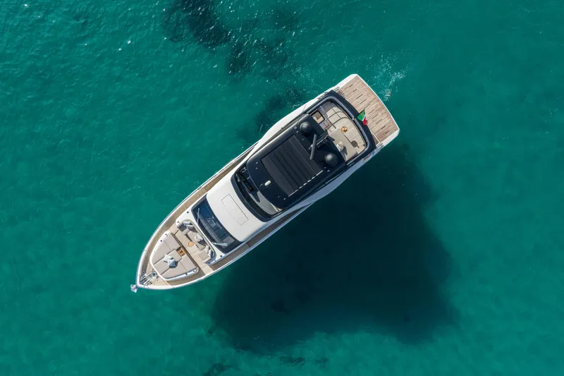 Slide: The Image of Aerial view of 2026 Cranchi Sessantadue 62 yacht on clear turquoise water. - 1