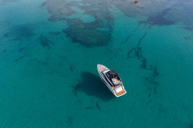 Slide: The Image of Aerial view of 2026 Cranchi Sessantadue 62 yacht on clear turquoise water. - 19