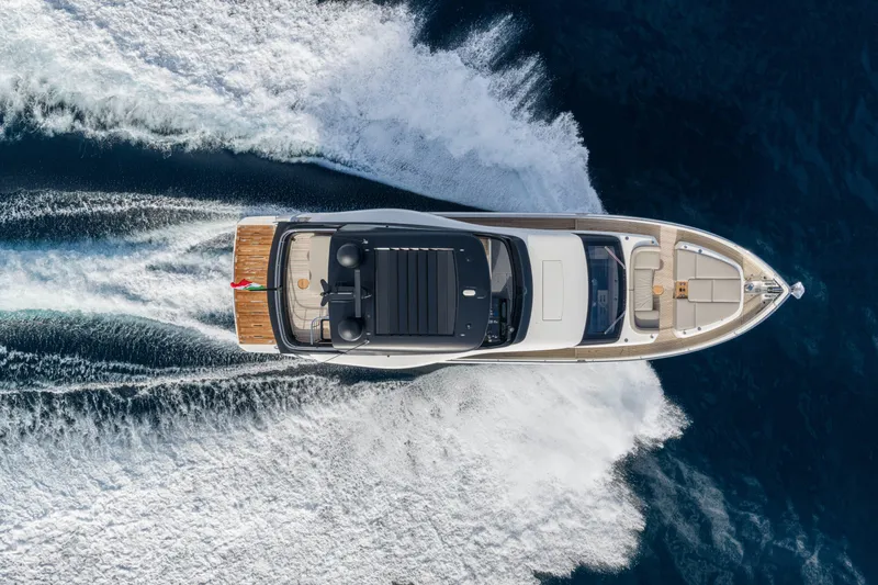 Slide: The Image of Aerial view of 2026 Cranchi Sessantadue 62 yacht cruising on open water. - 23