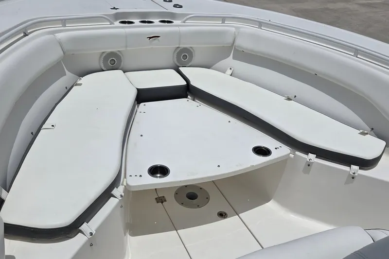 Slide: The Image of 2015 Tidewater 280 CC Adventure boat interior with cushioned seating and cup holders. - 14