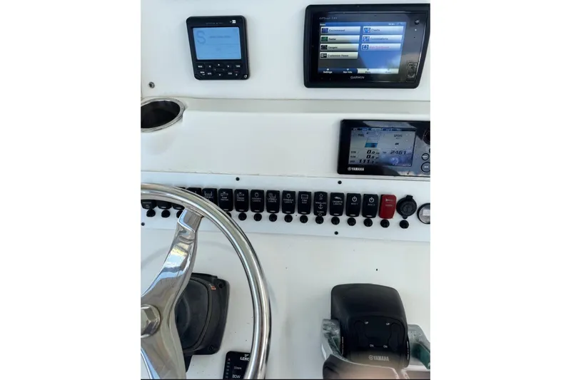 Slide: The Image of Control panel of 2015 Tidewater 280 CC Adventure boat with Garmin and Yamaha displays. - 17