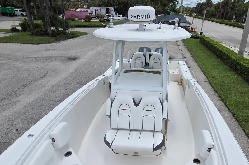 Slide: The Image of 2015 Tidewater 280 CC Adventure boat with Garmin equipment, featuring spacious seating and sleek design. - 13