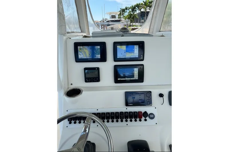 Slide: The Image of Control panel of 2015 Tidewater 280 CC Adventure boat with navigation screens. - 19