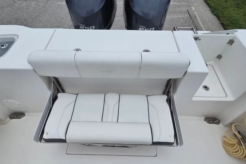 Slide: The Image of 2015 Tidewater 280 CC Adventure boat with white cushioned seating and dual Yamaha engines. - 5