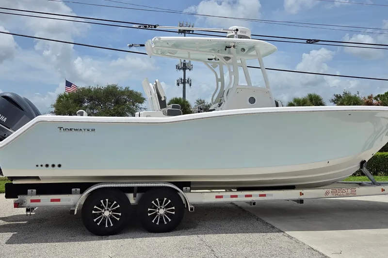 The Image of 2015 Tidewater 280 CC Adventure boat on trailer, side view, clear sky background. - 0