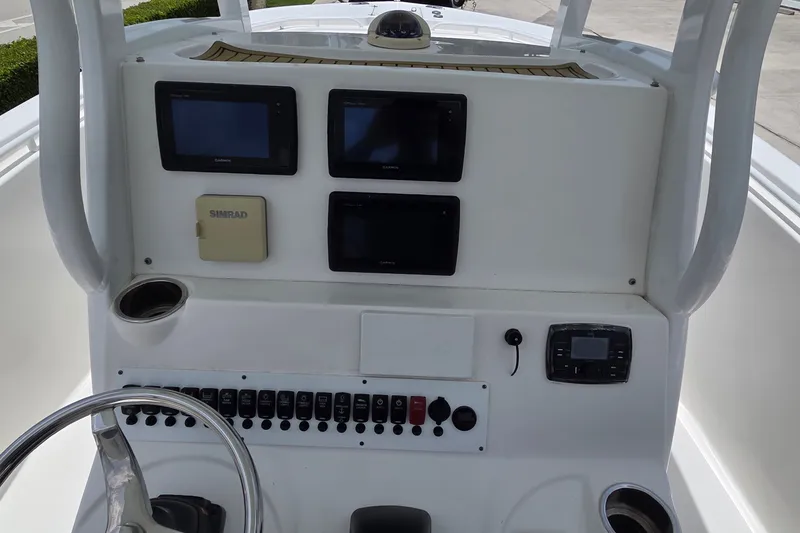 Slide: The Image of Control panel of 2015 Tidewater 280 CC Adventure boat with navigation screens and steering wheel. - 20
