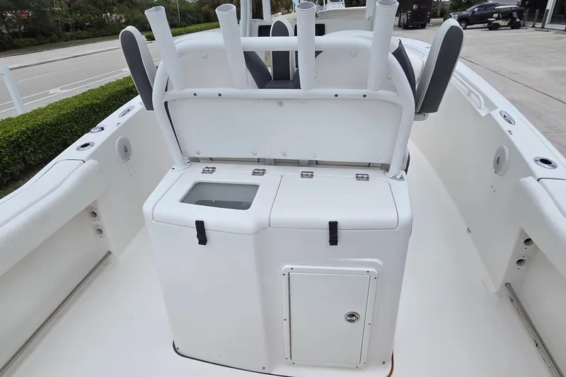 Slide: The Image of 2015 Tidewater 280 CC Adventure boat interior with rod holders and storage compartments. - 7