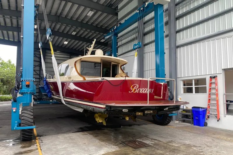 Slide: The Image of 2018 Palm Beach Motor Yachts PB50 in a boat lift at a marina. - 28
