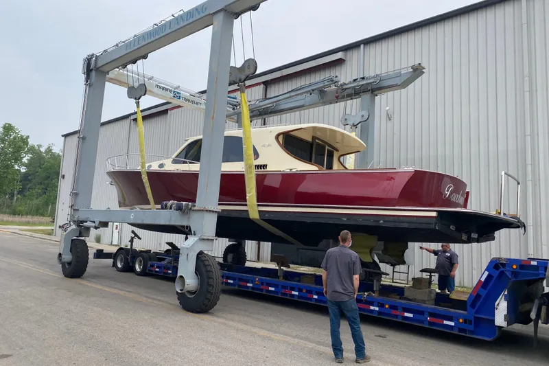 Slide: The Image of 2018 Palm Beach Motor Yachts PB50 being transported on a trailer at a shipyard. - 29