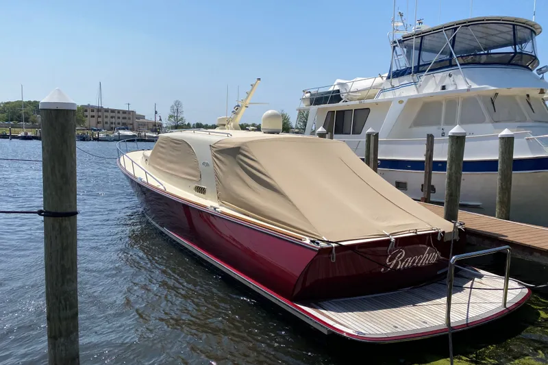 Slide: The Image of 2018 Palm Beach Motor Yachts PB50 docked, covered, with adjacent boats in marina. - 1