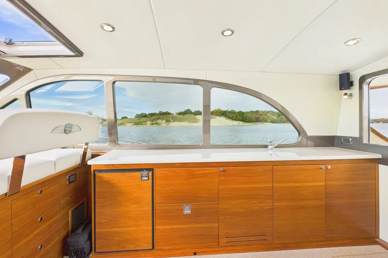 Slide: The Image of Luxurious interior of 2018 Palm Beach Motor Yachts PB50 with elegant wood cabinetry and scenic windows. - 9