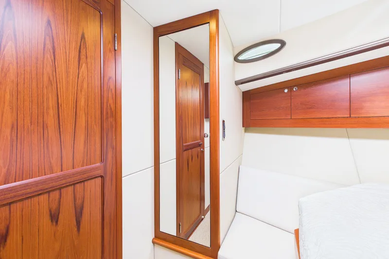 Slide: The Image of Interior of 2018 Palm Beach Motor Yachts PB50, featuring elegant wood paneling and mirror. - 20