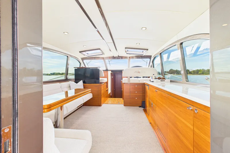 Slide: The Image of Luxurious interior of 2018 Palm Beach Motor Yachts PB50 with elegant wood finishes and panoramic windows. - 8