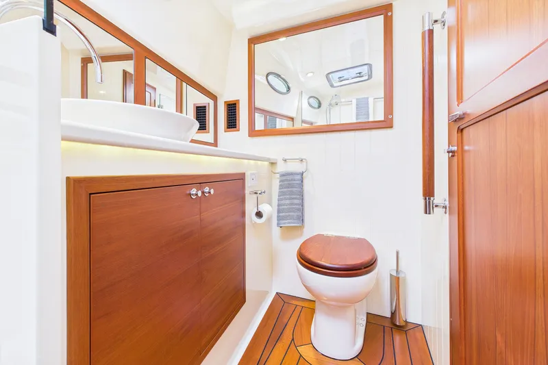 Slide: The Image of Luxurious 2018 Palm Beach Motor Yachts PB50 bathroom with wood accents and modern fixtures. - 26