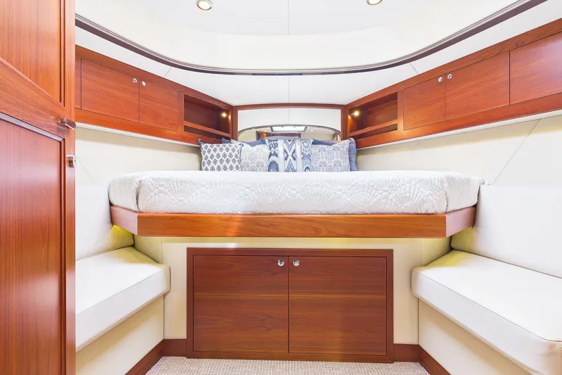 Slide: The Image of Luxurious 2018 Palm Beach Motor Yachts PB50 cabin interior with elegant wood finish and cozy bedding. - 18