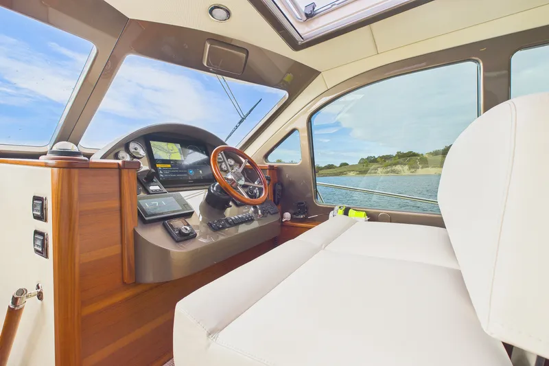 Slide: The Image of 2018 Palm Beach Motor Yachts PB50 helm with luxurious interior and scenic water view. - 4