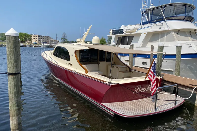 The Image of 2018 Palm Beach Motor Yachts PB50 docked, featuring sleek design and American flag. - 0