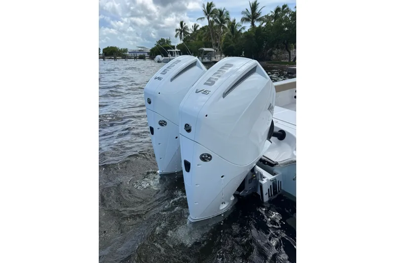 Slide: The Image of Twin outboard engines on a 2027 Blazer Bay Makaira 2800 boat in water. - 15