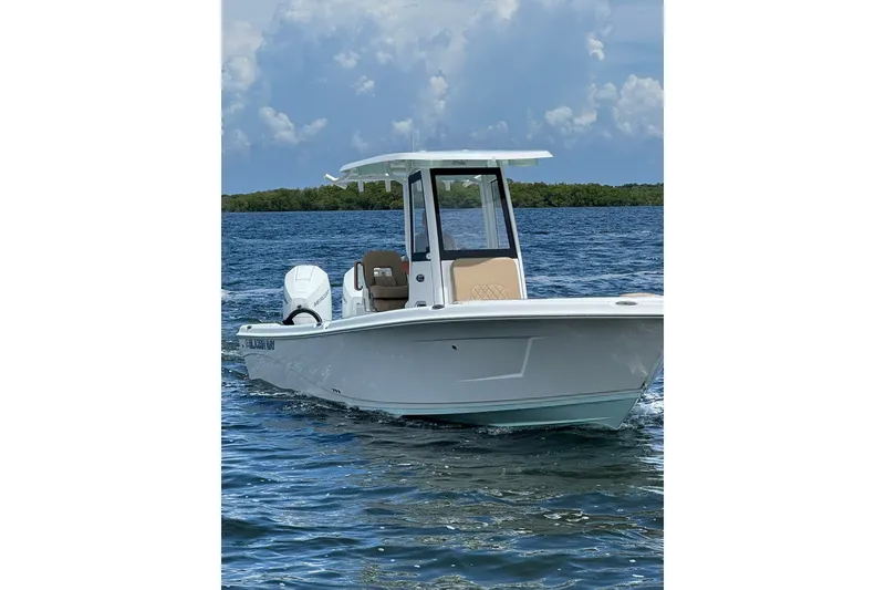 Slide: The Image of 2027 Blazer Bay Makaira 2800 boat cruising on open water under a cloudy sky. - 18