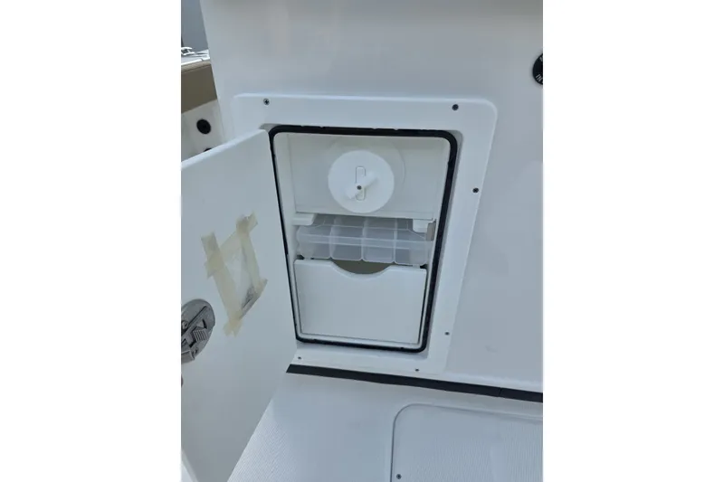 Slide: The Image of Open storage compartment on 2027 Blazer Bay Makaira 2800 boat, featuring organized interior space. - 14
