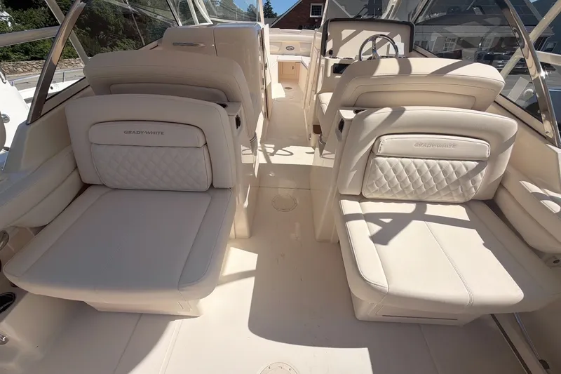 Slide: The Image of 2027 Grady-White Freedom 285 boat interior with luxurious seating and steering wheel. - 6