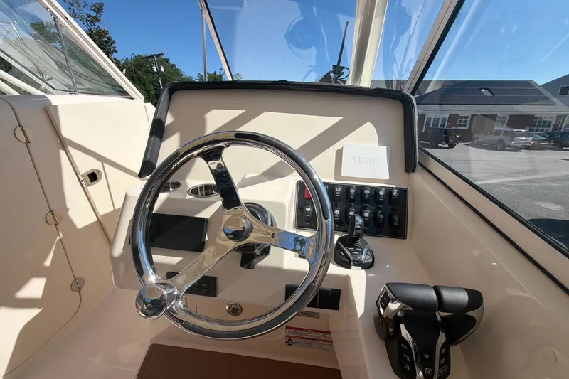 Slide: The Image of Steering console of 2027 Grady-White Freedom 285 boat with modern controls. - 8