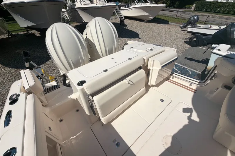 Slide: The Image of 2027 Grady-White Freedom 285 boat interior with dual engines and seating area. - 5