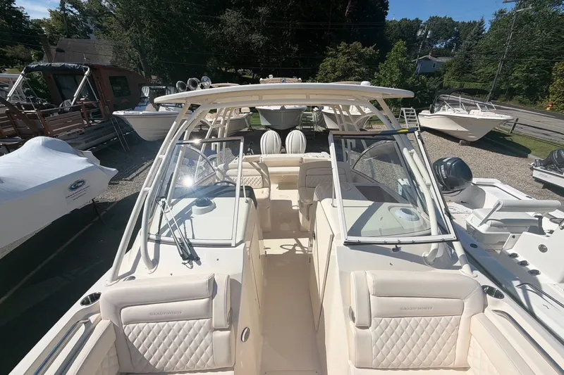 Slide: The Image of 2027 Grady-White Freedom 285 boat with spacious seating and modern design in a marina setting. - 11
