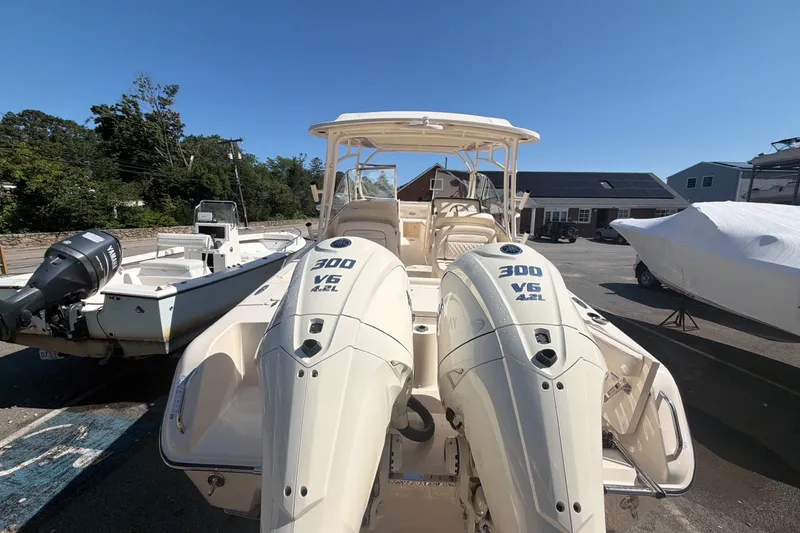 Slide: The Image of 2027 Grady-White Freedom 285 boat with dual 300 V6 engines, parked outdoors. - 4