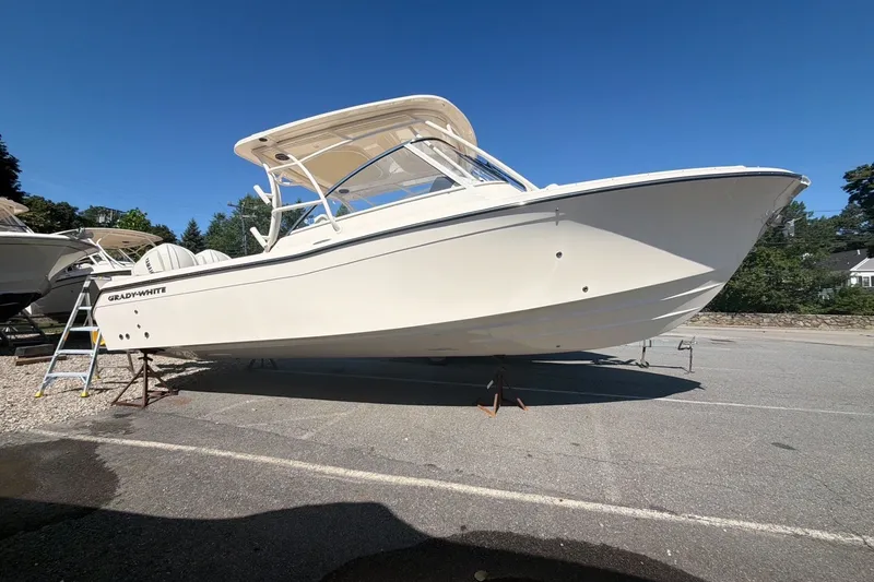 Slide: The Image of 2027 Grady-White Freedom 285 boat on display under clear blue sky. - 2