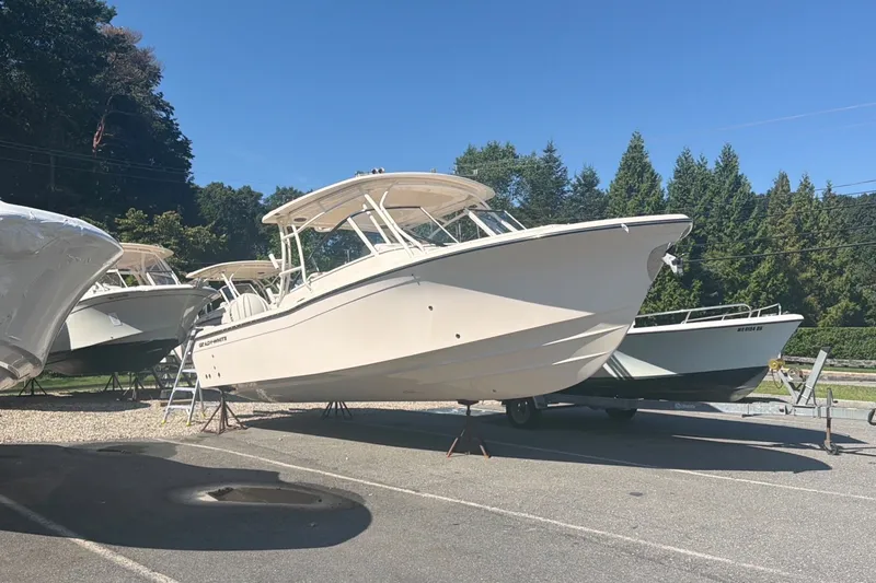 Slide: The Image of 2027 Grady-White Freedom 285 boat displayed outdoors on a sunny day. - 1