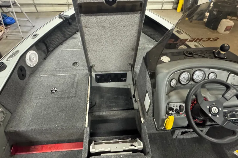 Slide: The Image of 2004 Lund 1775 Pro-V SE boat interior with steering wheel and dashboard controls. - 10