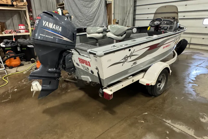 Slide: The Image of 2004 Lund 1775 Pro-V SE boat with Yamaha outboard motor in a garage setting. - 3