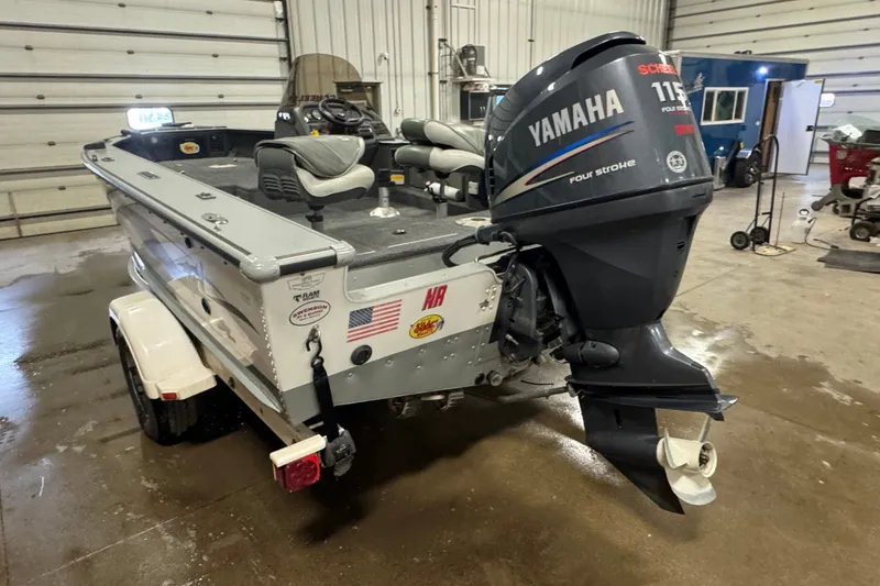 Slide: The Image of 2004 Lund 1775 Pro-V SE boat with Yamaha 115 outboard motor in a garage setting. - 4