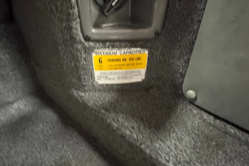 Slide: The Image of 2004 Lund 1775 Pro-V SE boat capacity label, indicating maximum of 6 persons or 945 lbs. - 7